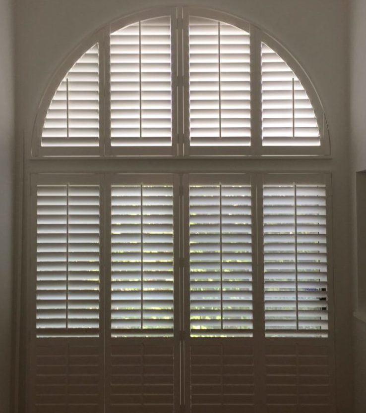 White Shutters Installed on Double Doors and Circle Top Window